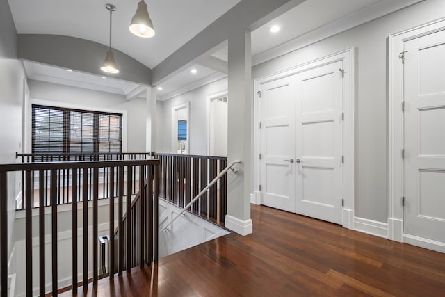 hallway with vaulted ceiling, baseboards, dark wood finished floors, and an upstairs landing