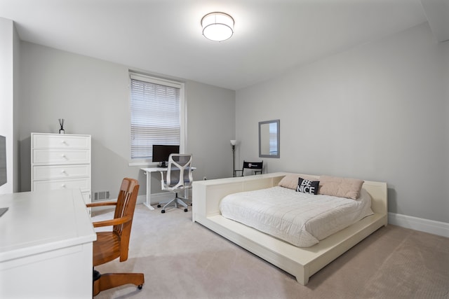 bedroom with visible vents, baseboards, and light colored carpet