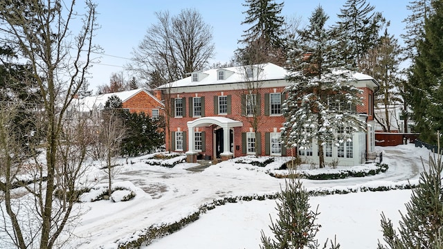 georgian-style home with brick siding