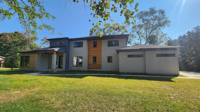 back of house with a lawn