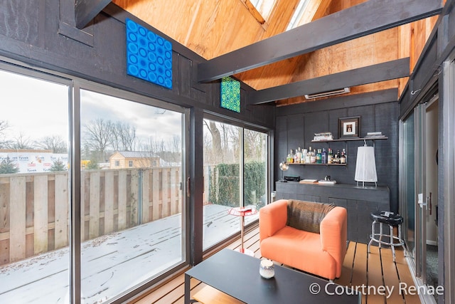 interior space featuring bar area and beam ceiling