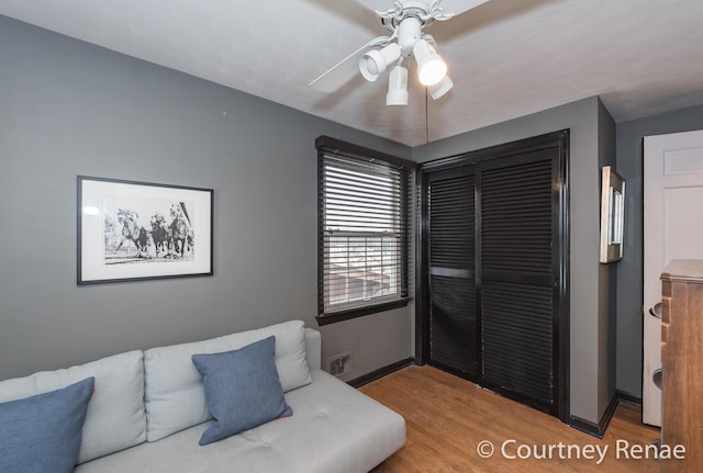 bedroom with wood-type flooring, a closet, and ceiling fan