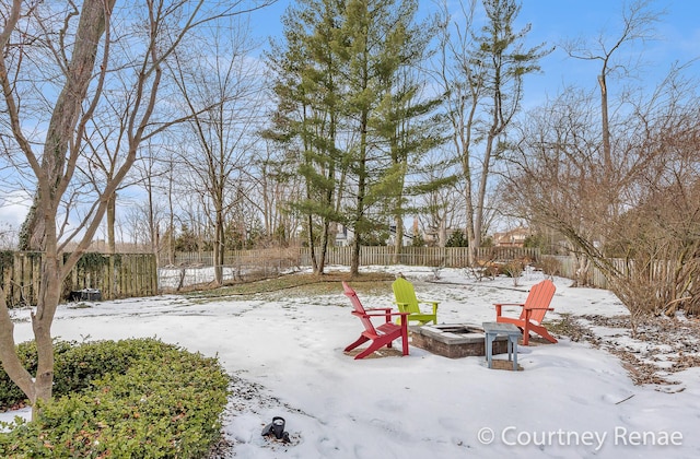 yard covered in snow featuring a fire pit