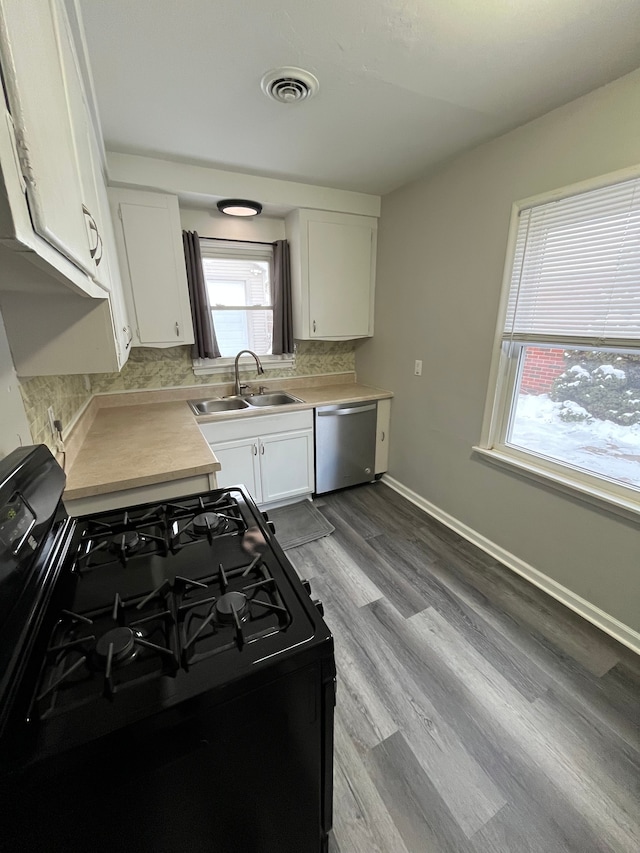 kitchen featuring sink, black range with gas stovetop, white cabinets, and dishwasher