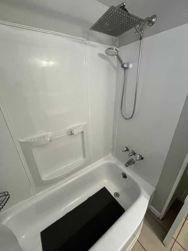 bathroom with washtub / shower combination and tile patterned floors