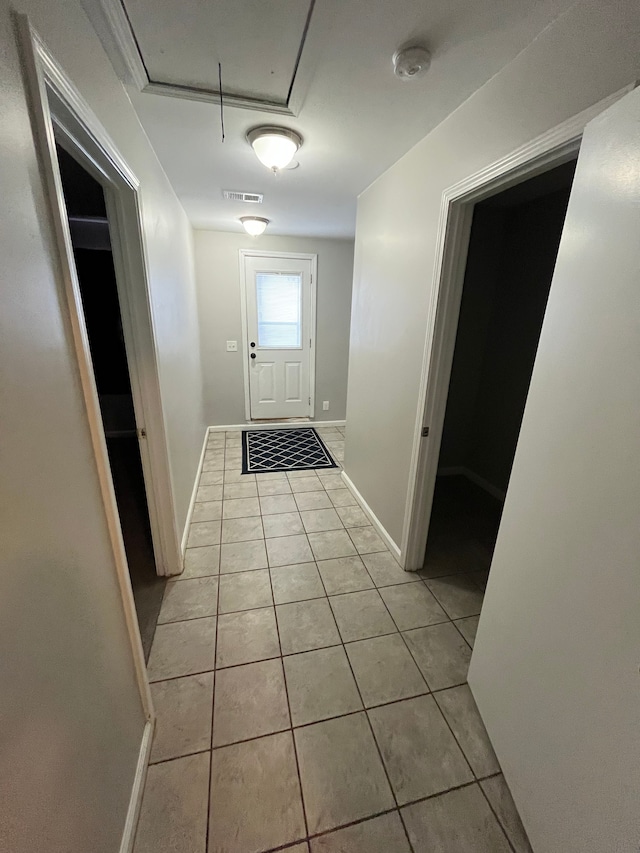 hallway featuring light tile patterned flooring