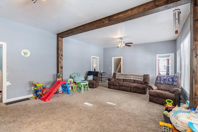 game room featuring beam ceiling, carpet floors, and ceiling fan