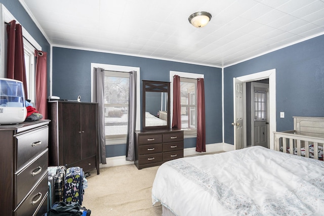 bedroom with crown molding and light colored carpet