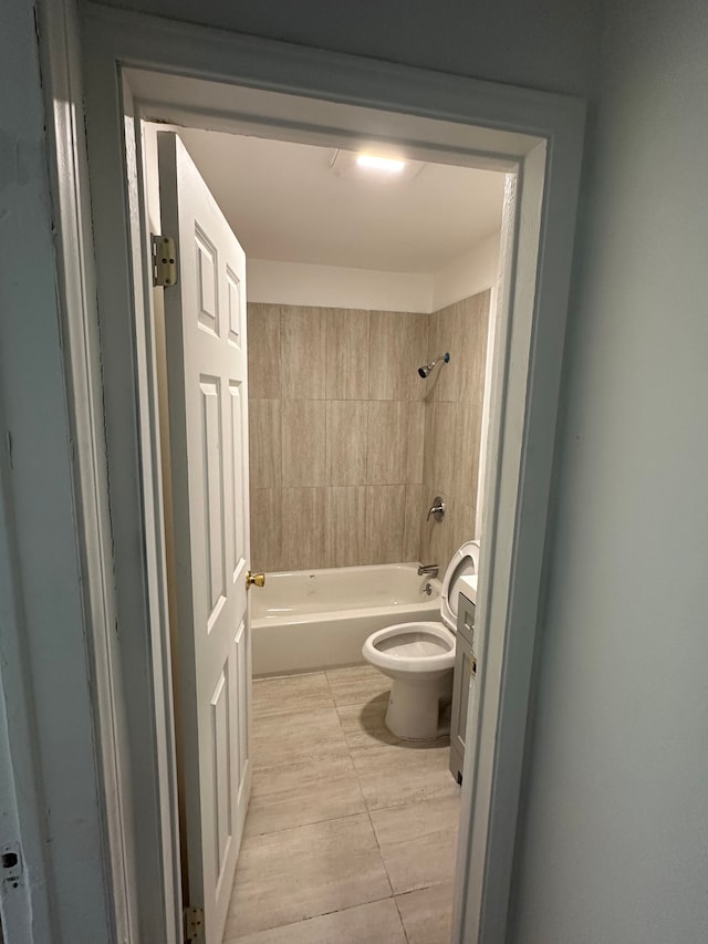 full bathroom featuring vanity, tile patterned flooring, tiled shower / bath, and toilet