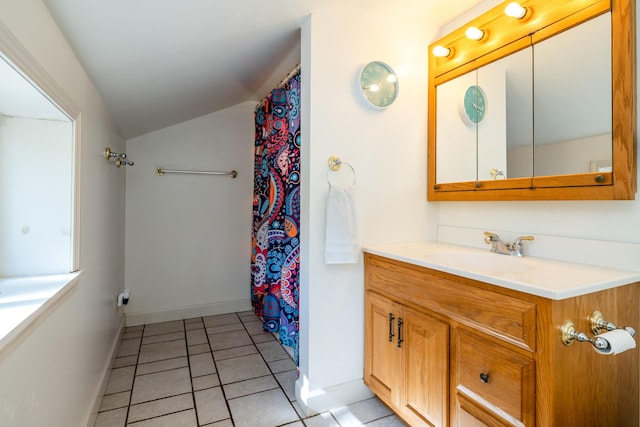 bathroom featuring vanity, vaulted ceiling, and tile patterned floors