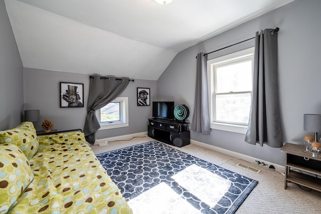 carpeted bedroom featuring multiple windows and vaulted ceiling