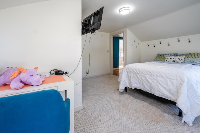 carpeted bedroom with vaulted ceiling