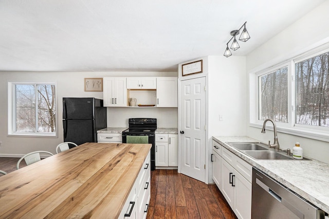 kitchen with butcher block countertops, white cabinetry, sink, black appliances, and dark wood-type flooring