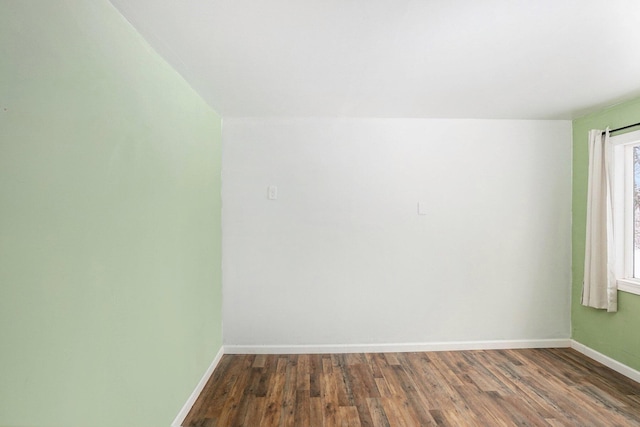 empty room with dark hardwood / wood-style floors