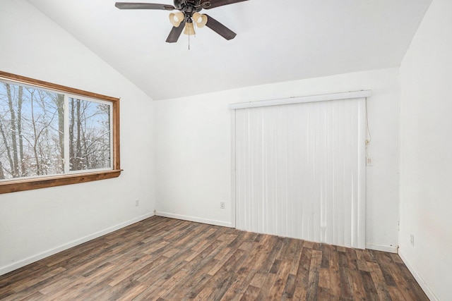 unfurnished room with vaulted ceiling, dark hardwood / wood-style floors, and ceiling fan