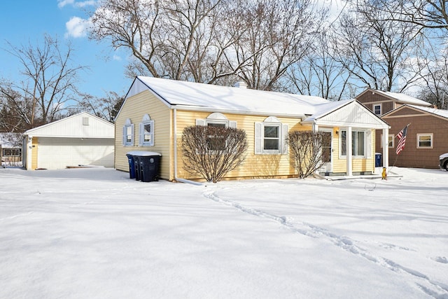 exterior space with a garage and an outbuilding