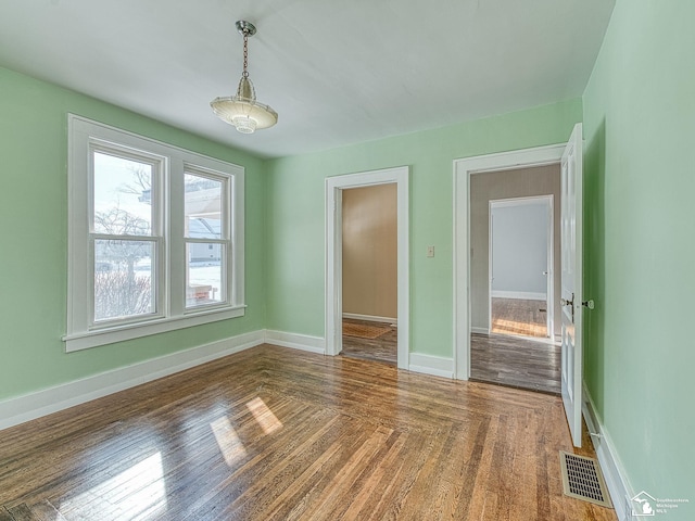 unfurnished room featuring dark wood-type flooring