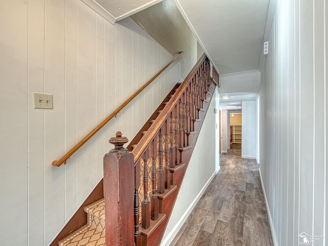 stairs featuring hardwood / wood-style floors