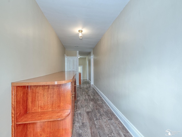 corridor with dark hardwood / wood-style flooring