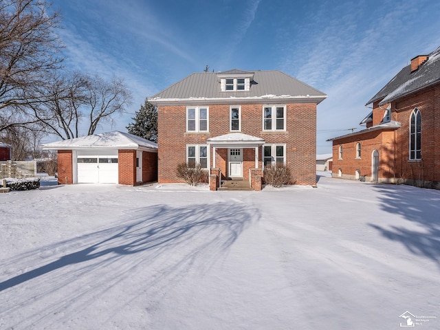 view of front of property with a garage and an outdoor structure