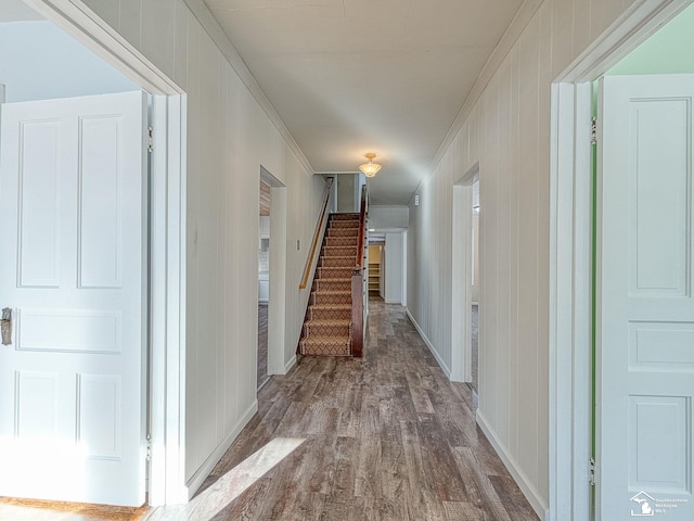 hallway with crown molding and wood-type flooring