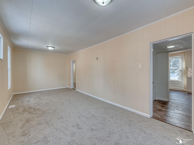 carpeted empty room featuring ornamental molding