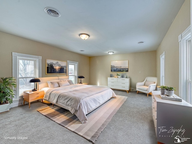 carpeted bedroom featuring multiple windows