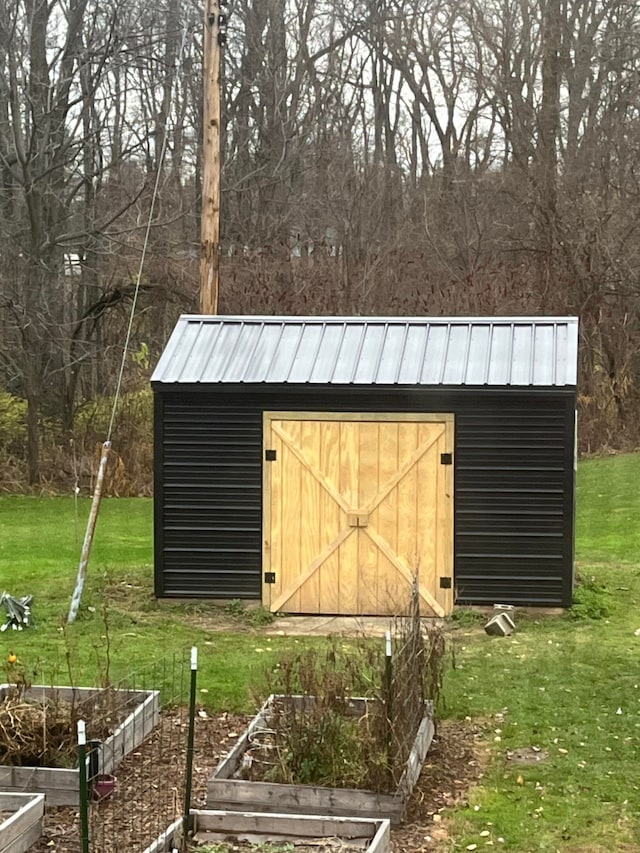 view of outbuilding with a lawn