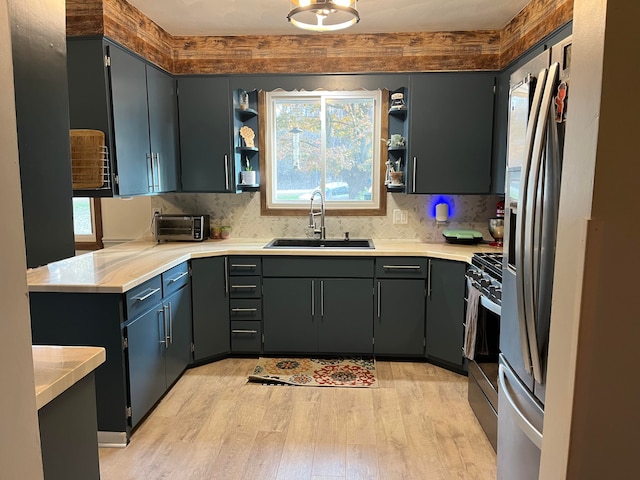 kitchen featuring light hardwood / wood-style floors, appliances with stainless steel finishes, sink, and a wealth of natural light