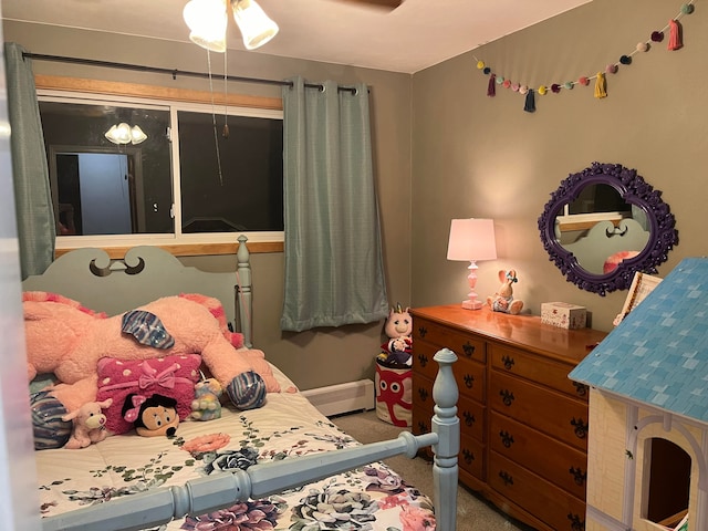 carpeted bedroom featuring a baseboard heating unit