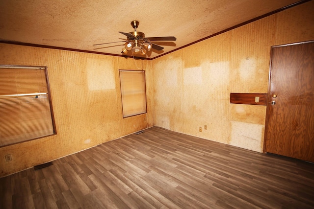 unfurnished room featuring ornamental molding, dark hardwood / wood-style floors, a textured ceiling, and ceiling fan