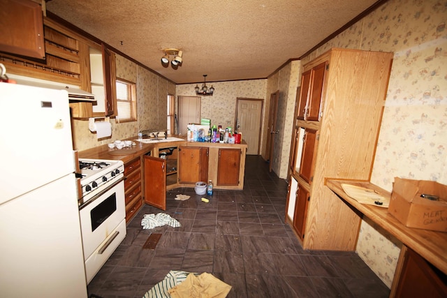 kitchen featuring sink, hanging light fixtures, ornamental molding, white appliances, and a textured ceiling