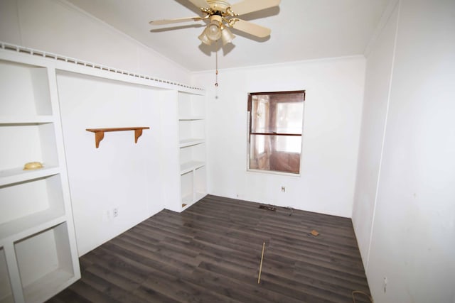 spare room with crown molding, ceiling fan, vaulted ceiling, and dark wood-type flooring