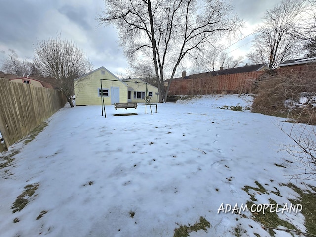 yard covered in snow with an outdoor structure