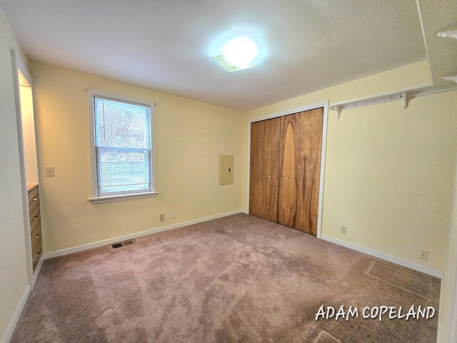 unfurnished bedroom featuring carpet floors and electric panel