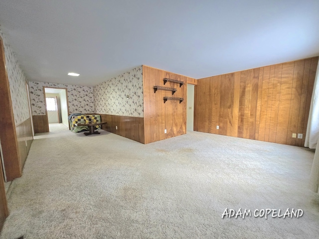 bonus room featuring wooden walls and carpet flooring