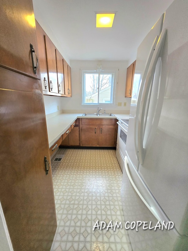 kitchen with sink and white appliances