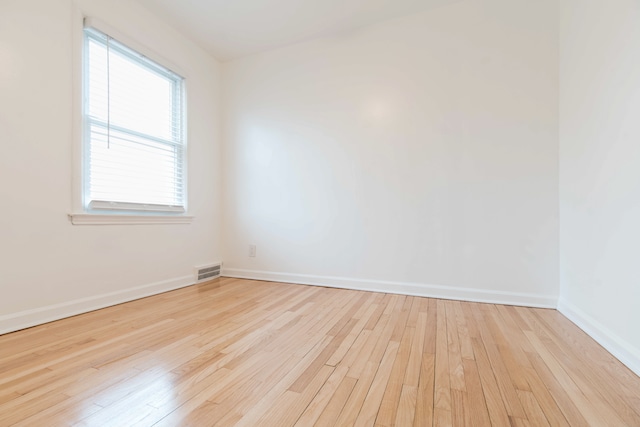 spare room with light wood-type flooring