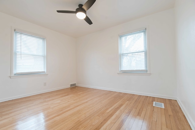 empty room with light hardwood / wood-style flooring and ceiling fan