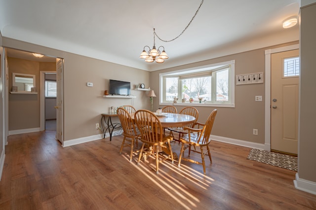 dining space with a chandelier and wood-type flooring