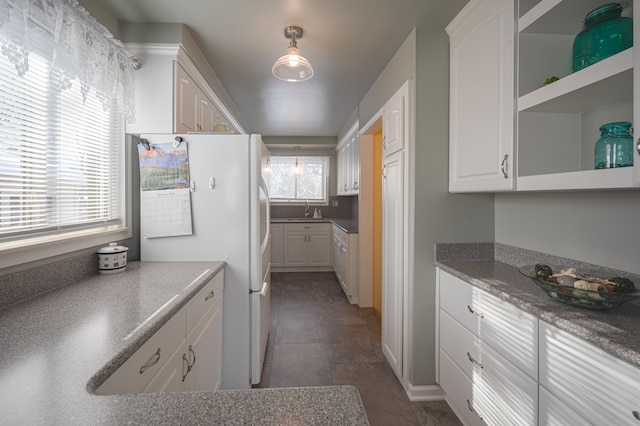 kitchen with white cabinets and a healthy amount of sunlight