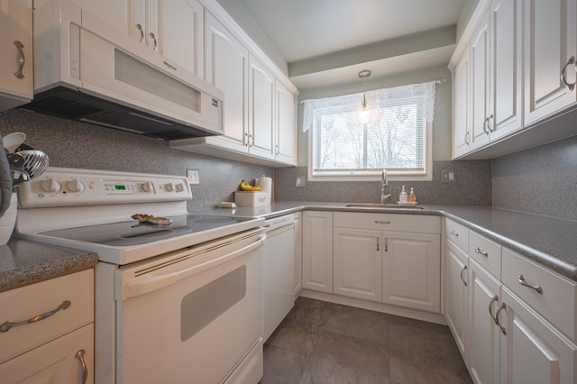 kitchen featuring white appliances, decorative light fixtures, backsplash, sink, and white cabinetry