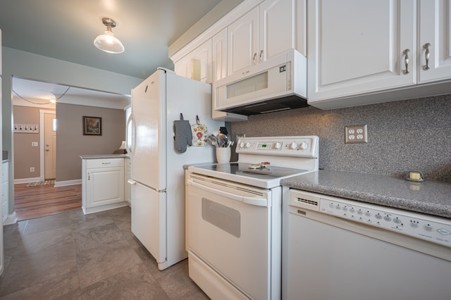 kitchen with backsplash, white appliances, and white cabinets