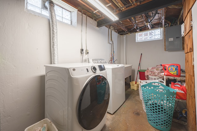 clothes washing area with electric panel and washer and clothes dryer