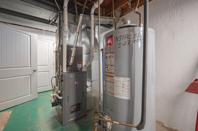 utility room featuring heating unit and gas water heater