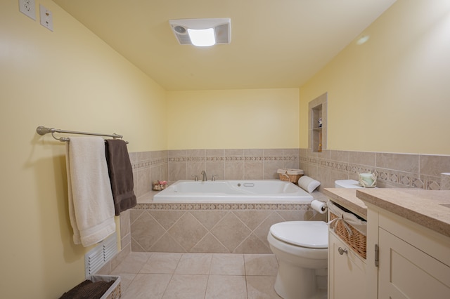 bathroom with tile patterned floors, vanity, toilet, and a relaxing tiled tub