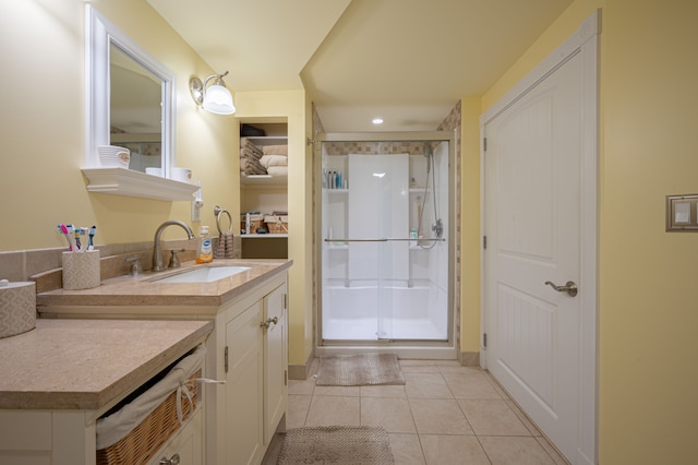 bathroom with tile patterned flooring, vanity, and a shower with shower door