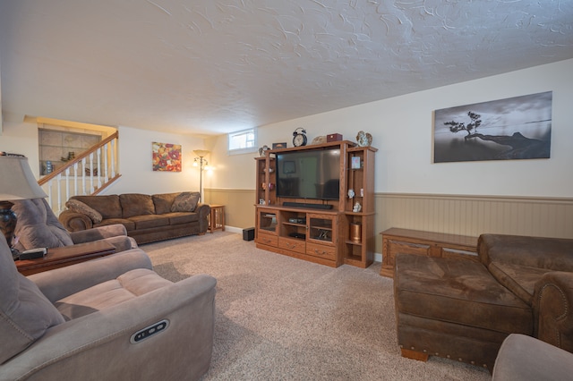 living room featuring carpet flooring and a textured ceiling