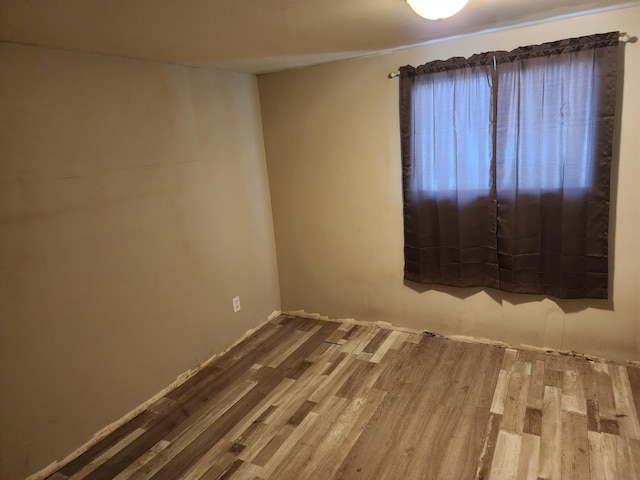 spare room with hardwood / wood-style flooring