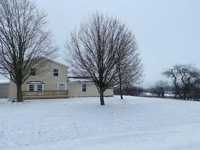 yard layered in snow featuring a wooden deck